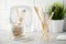 No plastic concept. Eco friendly bathroom accessories. Bamboo toothbrushes, cotton pads and cotton buds on a light gray