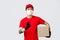 No problem we deliver your parcel. Asian delivery guy in uniform, red cap and t-shirt, showing okay sign, guarantee