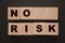 No risk words Wooden cubes . Low risk investment business or Healthcare concept