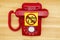 No Robo Call message on a sticky note on a red old retro rotary phone