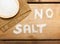 No salt text on salt and bowl on  wooden background