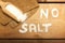 No salt text on salt and spoon on  wooden background