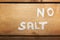 No salt text on salt on  wooden background