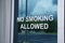 No smoking allowed letters on glass window