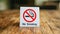 No Smoking label in the public. No smoking sign on wood table at hotel