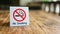 No Smoking label in the public. No smoking sign on wood table at hotel