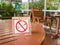 No smoking sign displayed on the wooden table