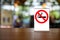 No smoking sign with shopping place background on wooden table