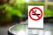 No smoking sign with shopping place background on wooden table