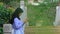 No sound Standing Indonesia Muslimah or Islam girl playing kalimba at yard