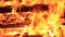 No sound. Thirty 30 seconds. Detail and extreme close-up of burning picnic bench at the end of a party.