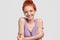 No stress, time for good emotions. Charming red head teenage girl keeps hands crossed over chest, enjoys pleasant