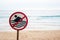 No swimming allowed sign at the beach with strong sea wave by the beach background.