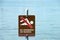 No Swimming or Wading warning sign by lake
