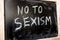 No To Sexism written in white chalk on a black chalkboard.