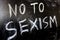 No To Sexism written in white chalk on a black chalkboard.