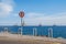 No trespass sign at end of road with ocean background,