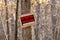 No Trespassing sign posted for rural wooded property during autumn, selective focus, background blur, foreground blur