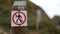 No Trespassing Sign on a Wooden Pole with a Blurry Coastline as Background