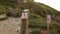 No Trespassing Signs on Wooden Poles with a Blurry Coastline as Background