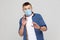No, wait. Portrait of scared young man in casual style with surgical medical mask standing and looking at camera, afraid and panic