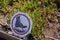 No walking boot cross out sign in front of garden with plants growing