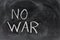 No war, handwritten with a chalk on the blackboard