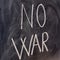 No war, handwritten with a chalk on the blackboard