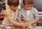 No, youre doing it wrong. two young brothers baking in the kitchen.