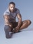 Nobody likes stiff muscles. Full length shot of a handsome young man sitting and stretching in the studio.