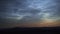 Noctilucent clouds shining in summer night sky timelapse