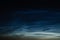 Noctilucent mesospheric clouds in night sky. Rare atmospheric phenomenon over city.