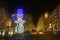 Nocturnal street scene on the Kurfuerstendamm in Berlin with Christmas lights and a great snowman made of small lamps