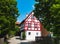 NOERDLINGEN, Germany- May 13, 2018: Typical German Timbered House in Bayern, isolated under Trees