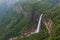 Nohkalikai waterfall surrounded by high cliffs and woodland and thick vegetation near Cherrapunji