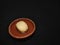 Nolen gur rosogolla or rasgulla served on plate. brown spongy bengali indian traditional sweet made from cottage cheese and