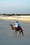 Nomad riding a camel in the desert