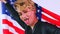 non binary portrait of asian man with luxurious blonde hair and gorgeous make-up wawing usa flag