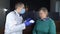 Non-contact thermometer. Doctor measures the body temperature of a senior woman. Therapist examines a woman who complains of fever