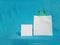 Non woven fabric grocery bags on blue background. ECO Friendly Tote promotional products shopper bags