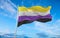 Nonbinary flag waving in the wind at cloudy sky. Freedom and love concept. Pride month. activism, community and freedom Concept.