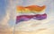 Nonbinary lesbian pride flag waving in the wind at cloudy sky. Freedom and love concept. Pride month. activism, community and