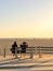 Nondescript couple sitting on a bench off the bike path off Santa Monica Beach