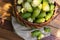 Noni basket and noni on Brown cloth on wooden table with nature background,Top view.