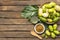 Noni fruit and noni in the basket with noni juice and noni powder on wooden table.Top view