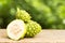 Noni fruit and noni slice on wooden table and green background.Fruit for health and herb for health.110