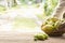 Noni fruit on wooden table.And noni basket in his hand.Zoom in1