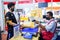 Nonthaburi, THAILAND - MAY 24, 2020 : Asian staff wearing mask working at the post office with customer at counter service