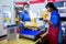 Nonthaburi, THAILAND - MAY 24, 2020 : Asian staff working at the post office with barcode reader and print slip for customer at