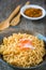 Noodle in ceramic bowl with crab stick on wooden background.